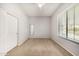 Empty bedroom featuring neutral carpet, window, closet and neutral walls at 6808 W Angela Dr, Glendale, AZ 85308