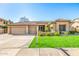 Charming single-story home featuring a well-manicured lawn, three-car garage, and tile roof at 6808 W Angela Dr, Glendale, AZ 85308