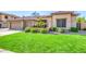 Well-kept lawn with green grass and desert landscaping at 6808 W Angela Dr, Glendale, AZ 85308