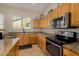 Bright kitchen boasts granite counters, stainless appliances, and ample cabinet space for storage and meal preparation at 6808 W Angela Dr, Glendale, AZ 85308