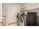 Laundry room with washer, dryer, storage shelf and door at 6808 W Angela Dr, Glendale, AZ 85308