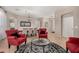 Living room with four red chairs, a round coffee table, and dining area in the background at 6808 W Angela Dr, Glendale, AZ 85308