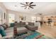 Spacious living room with a sectional sofa and open to the kitchen at 6808 W Angela Dr, Glendale, AZ 85308
