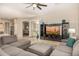 Open-concept living room with sectional sofa, entertainment center, and view to the kitchen and dining at 6808 W Angela Dr, Glendale, AZ 85308