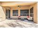 A covered patio has ample seating and windows, offering relaxation and shade at 6808 W Angela Dr, Glendale, AZ 85308