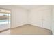 Bright bedroom with tile floors, double closets, and a glass door leading to backyard at 726 N 78Th St, Scottsdale, AZ 85257