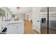 Open concept floorplan with modern kitchen, stainless steel appliances, and wood floors at 7500 E Deer Valley Rd # 132, Scottsdale, AZ 85255