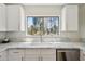Bright kitchen featuring marble countertops, white cabinets, and a window overlooking the backyard at 7500 E Deer Valley Rd # 132, Scottsdale, AZ 85255