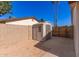 Backyard features storage shed, block fence, and desert landscaping at 815 W El Prado Rd, Chandler, AZ 85225