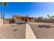 Expansive gravel backyard with covered patio and block fencing for privacy at 815 W El Prado Rd, Chandler, AZ 85225