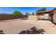 Expansive backyard with gravel, covered patio, and block fencing at 815 W El Prado Rd, Chandler, AZ 85225