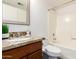 Bathroom featuring a granite countertop, wood vanity, and a shower/tub combo at 815 W El Prado Rd, Chandler, AZ 85225