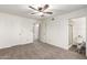 Bedroom with neutral carpet, ceiling fan, and access to a bathroom at 815 W El Prado Rd, Chandler, AZ 85225