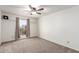Bedroom features neutral carpet, ceiling fan, and a window offering natural light at 815 W El Prado Rd, Chandler, AZ 85225