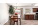 Cozy dining area adjacent to the kitchen, complete with stylish chandelier and sliding door access to backyard at 815 W El Prado Rd, Chandler, AZ 85225