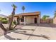Single story home with desert landscaping, mature palm trees, and covered parking space at 815 W El Prado Rd, Chandler, AZ 85225