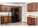 Modern kitchen featuring granite countertops, wood cabinets, stainless steel fridge, and neutral flooring at 815 W El Prado Rd, Chandler, AZ 85225