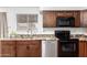 Galley kitchen with granite countertops, wood cabinets, stainless steel appliances, and a window at 815 W El Prado Rd, Chandler, AZ 85225