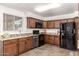 Well-equipped kitchen features granite countertops, wood cabinets, stainless steel appliances, and ample counter space at 815 W El Prado Rd, Chandler, AZ 85225