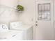 Functional laundry room with appliances, shelving, and access to the backyard at 815 W El Prado Rd, Chandler, AZ 85225