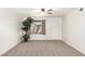 Bright living room with neutral carpeting, a large window, and a white front door at 815 W El Prado Rd, Chandler, AZ 85225
