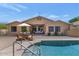 Inviting backyard with a pool, outdoor dining area, and a covered patio perfect for entertaining at 8210 W Wethersfield Rd, Peoria, AZ 85381