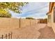 Spacious backyard area featuring a rock garden and a tall stucco wall, providing privacy at 8210 W Wethersfield Rd, Peoria, AZ 85381