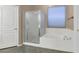 Bright bathroom featuring soaking tub and glass-enclosed shower at 8210 W Wethersfield Rd, Peoria, AZ 85381