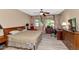 Cozy bedroom featuring ceiling fan, wood look flooring, and neutral colors at 8210 W Wethersfield Rd, Peoria, AZ 85381