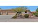 Charming single-story home with a well-maintained front yard and a two-car garage at 8210 W Wethersfield Rd, Peoria, AZ 85381