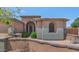 Attractive home with a landscaped front yard, a decorative stone archway and a cozy sitting area at 8210 W Wethersfield Rd, Peoria, AZ 85381