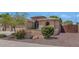 Inviting home with landscaped front yard and a two-car garage, with stone accents on facade at 8210 W Wethersfield Rd, Peoria, AZ 85381