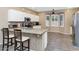 Bright kitchen featuring white cabinetry, stainless appliances, and a breakfast bar with seating at 8210 W Wethersfield Rd, Peoria, AZ 85381