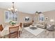 Open-concept living room and dining area filled with natural light at 8210 W Wethersfield Rd, Peoria, AZ 85381