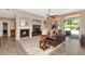 Comfortable living room with a fireplace, tile floors, and ample seating at 8210 W Wethersfield Rd, Peoria, AZ 85381