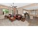 Spacious living room with tile flooring, views of the kitchen, and access to the backyard at 8210 W Wethersfield Rd, Peoria, AZ 85381