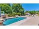 Relaxing backyard with a sparkling pool, rock waterfall, and lush landscaping for privacy at 8210 W Wethersfield Rd, Peoria, AZ 85381