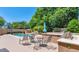Backyard featuring a pool, shaded seating area, outdoor dining space, and built-in grill at 8210 W Wethersfield Rd, Peoria, AZ 85381