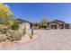 Charming desert home featuring mature landscaping, neutral colors, and a spacious paver driveway at 8555 E Tecolote Cir, Scottsdale, AZ 85266