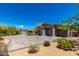 The large three-car garage features a tile roof and paved parking area, surrounded by desert landscaping at 8555 E Tecolote Cir, Scottsdale, AZ 85266