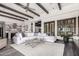 Spacious living room featuring wood beam ceilings, an oversized white sofa and hardwood floors at 8555 E Tecolote Cir, Scottsdale, AZ 85266