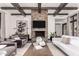 Bright living room with stone fireplace, exposed beams, and stylish furniture provides elegant living space at 8555 E Tecolote Cir, Scottsdale, AZ 85266