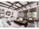 Bright open-concept living room with exposed wood beams, stylish furniture, and elegant lighting fixtures at 8555 E Tecolote Cir, Scottsdale, AZ 85266
