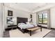Bedroom featuring a modern design with a decorative bench, hardwood floors and picture frame windows at 8555 E Tecolote Cir, Scottsdale, AZ 85266