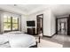 Bedroom featuring a modern design with a decorative bench, hardwood floors and picture frame windows at 8555 E Tecolote Cir, Scottsdale, AZ 85266