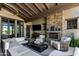Relaxing outdoor living area with stone fireplace, comfortable seating, and views of the surrounding landscape at 8555 E Tecolote Cir, Scottsdale, AZ 85266