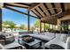 Inviting covered outdoor living space featuring comfortable seating and views of the sparkling pool at 8555 E Tecolote Cir, Scottsdale, AZ 85266
