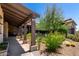 Outdoor patio featuring a covered walkway, lush landscaping, and stone accents offers a tranquil retreat at 8555 E Tecolote Cir, Scottsdale, AZ 85266