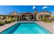 Beautiful pool with unobstructed views, lush landscaping, and covered patio in the background at 8555 E Tecolote Cir, Scottsdale, AZ 85266