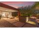 Stunning backyard with outdoor lounge and dining areas, water features, and desert landscape under a vibrant sunset at 9502 N 47Th St, Phoenix, AZ 85028